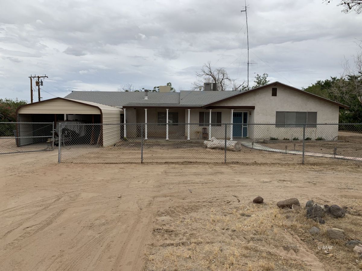 560 North Primavera Street Ridgecrest, CA 93555 - Photo 1 of 1 a backyard of a house with table and chairs