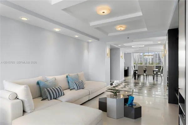 a living room with furniture and kitchen view