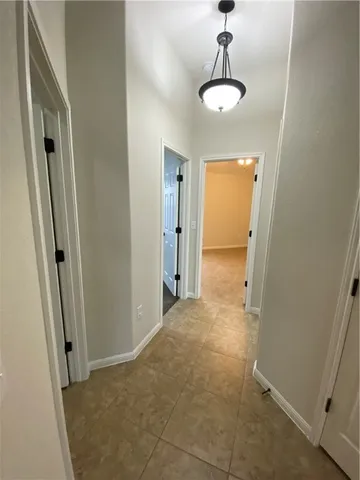 a view of a hallway with a chandelier