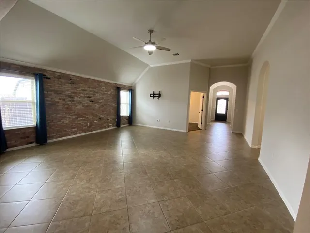 a view of a livingroom with wooden floor and a ceiling fan