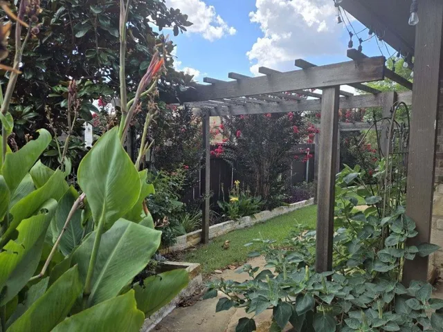 a view of a pathway of a house with a yard