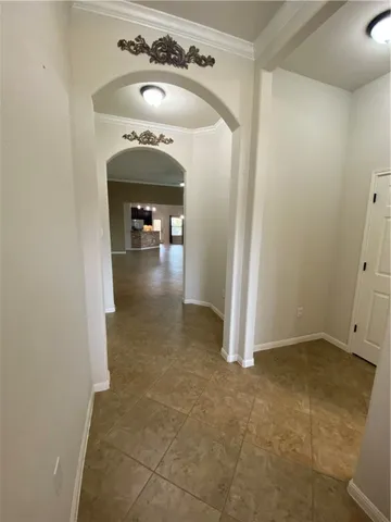 a view of a hallway to an empty room and fire place