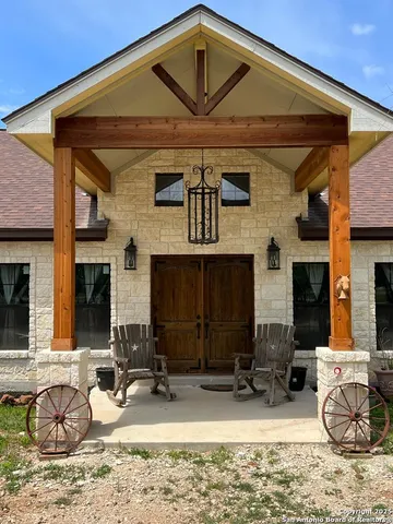 a front view of a house with cars parked