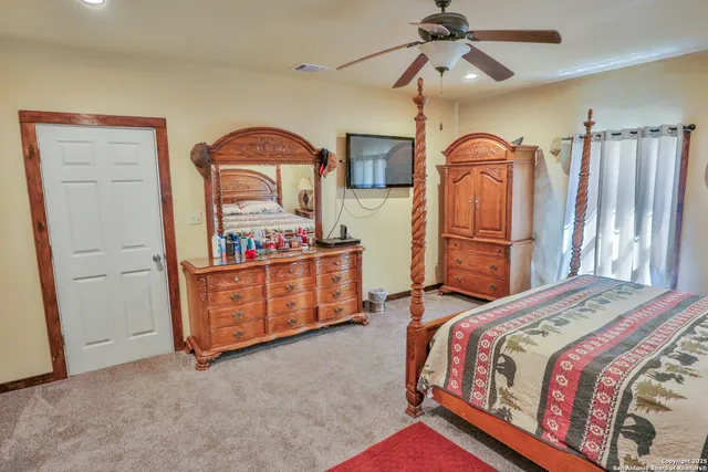 a bedroom with bed and cabinets