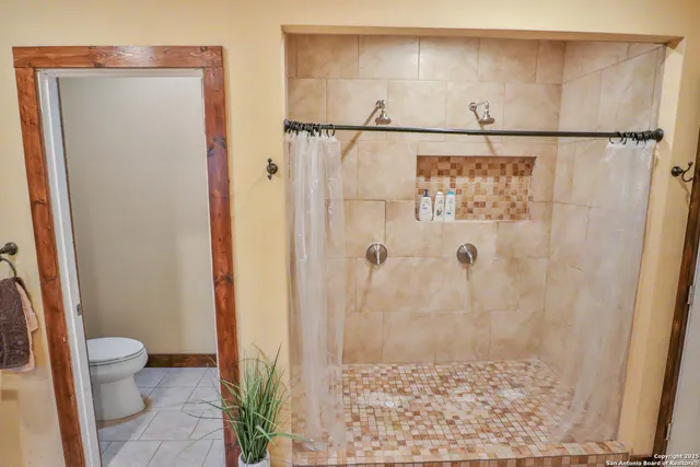 a bathroom with a shower and a toilet