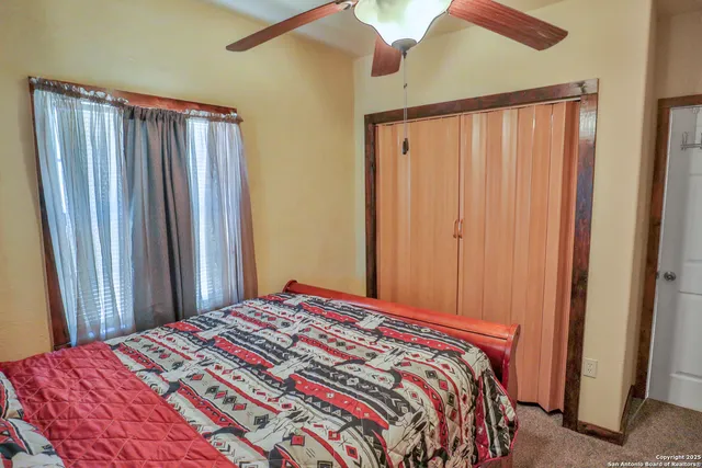 a bedroom with a bed and a mirror