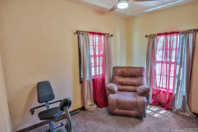 a livingroom with workspace and a couch