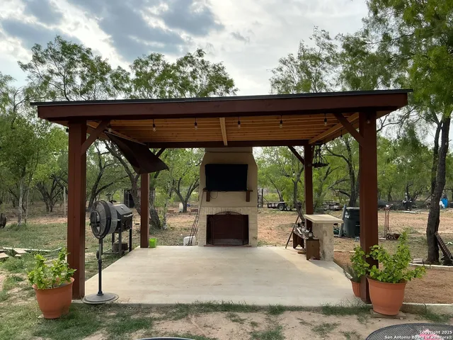 a view of a patio with a table chairs and a fireplace