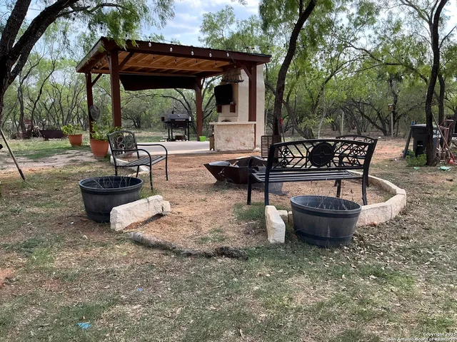 a view of a backyard with sitting area and furniture