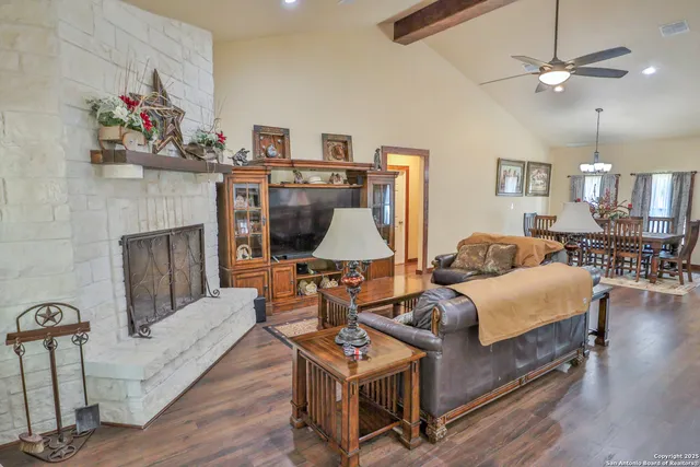 a living room with furniture and a fireplace