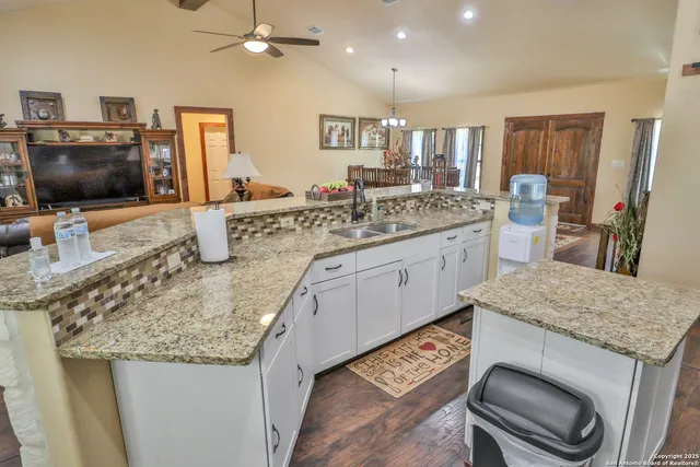 a kitchen with a stove a sink and a wooden cabinets