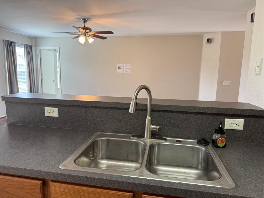 4514 Quail Run Road Sherman, TX 75092 - Photo 24 of 34 Kitchen featuring dark countertops and ceiling fan