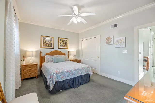 a bedroom with a bed and painting on the wall
