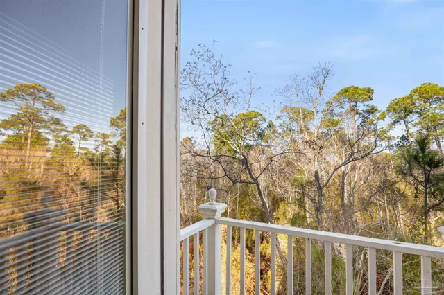 a view of a kitchen with kitchen island stainless steel appliances granite countertop a sink and a living room view
