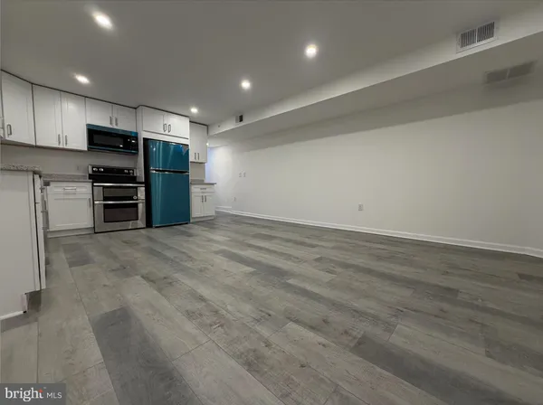 a bedroom with a bed couch and window