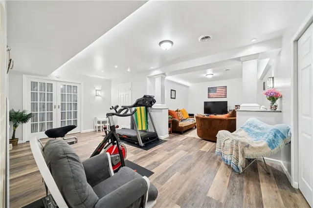 a living room with furniture and wooden floor