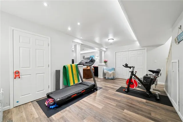 a living room with furniture and gym equipment