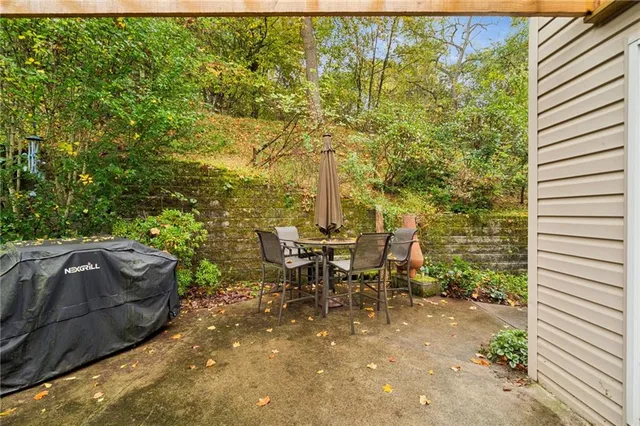 a view of a porch with furniture and a yard