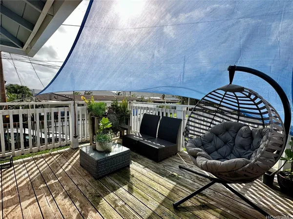 a view of a chairs and table in the balcony
