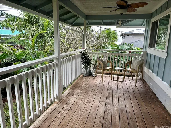 a view of balcony with chairs and wooden floor