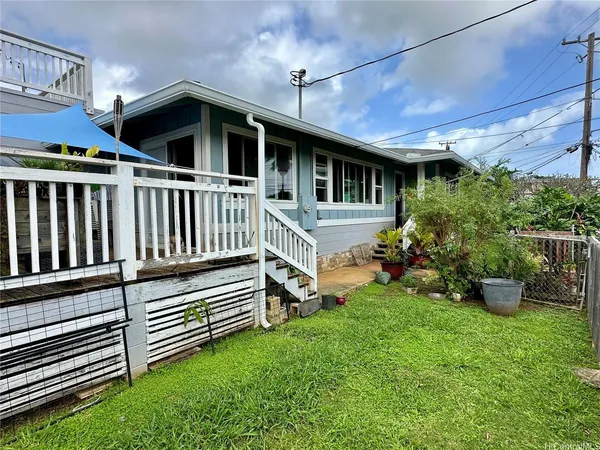 a view of a house with a yard and sitting area