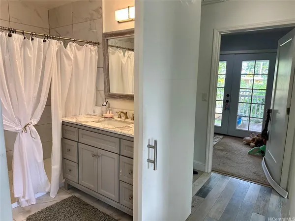 a bathroom with a sink a mirror and a shower