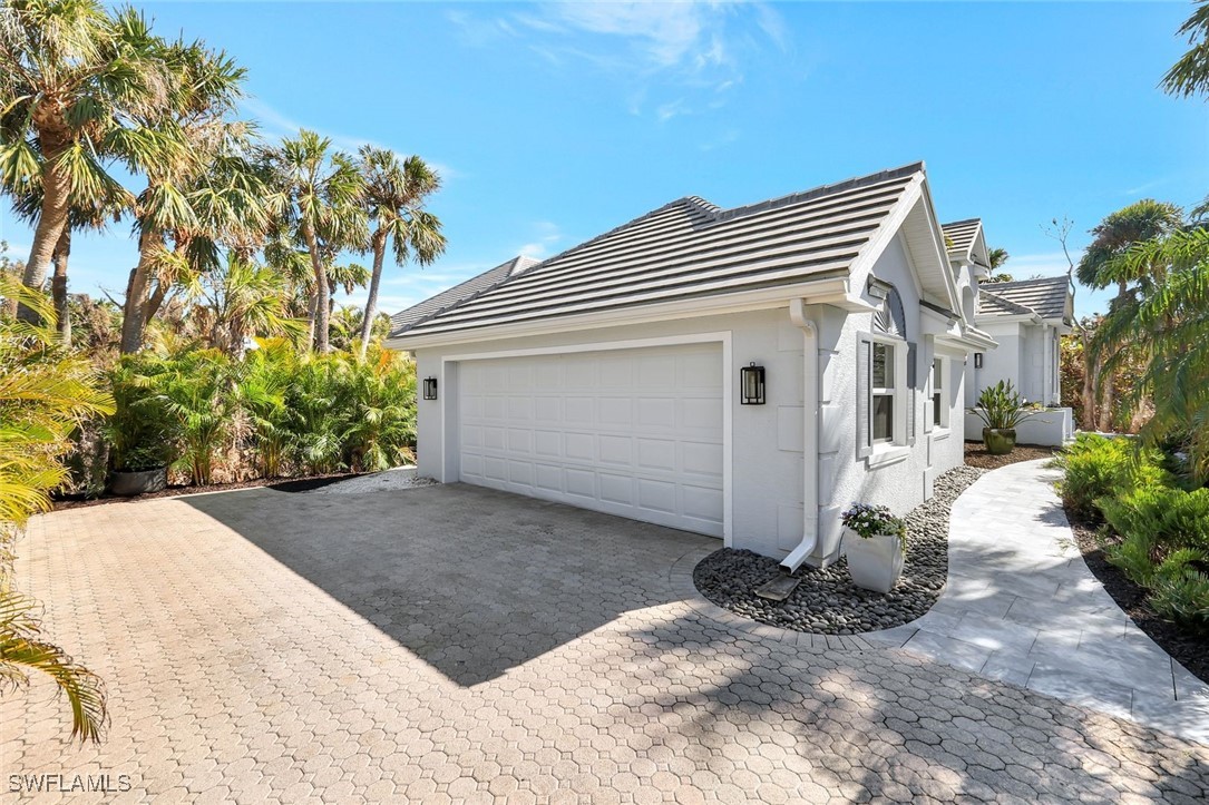 2450 Wulfert Road Sanibel, FL 33957 - Photo 4 of 44 a view of a house with a yard and plants