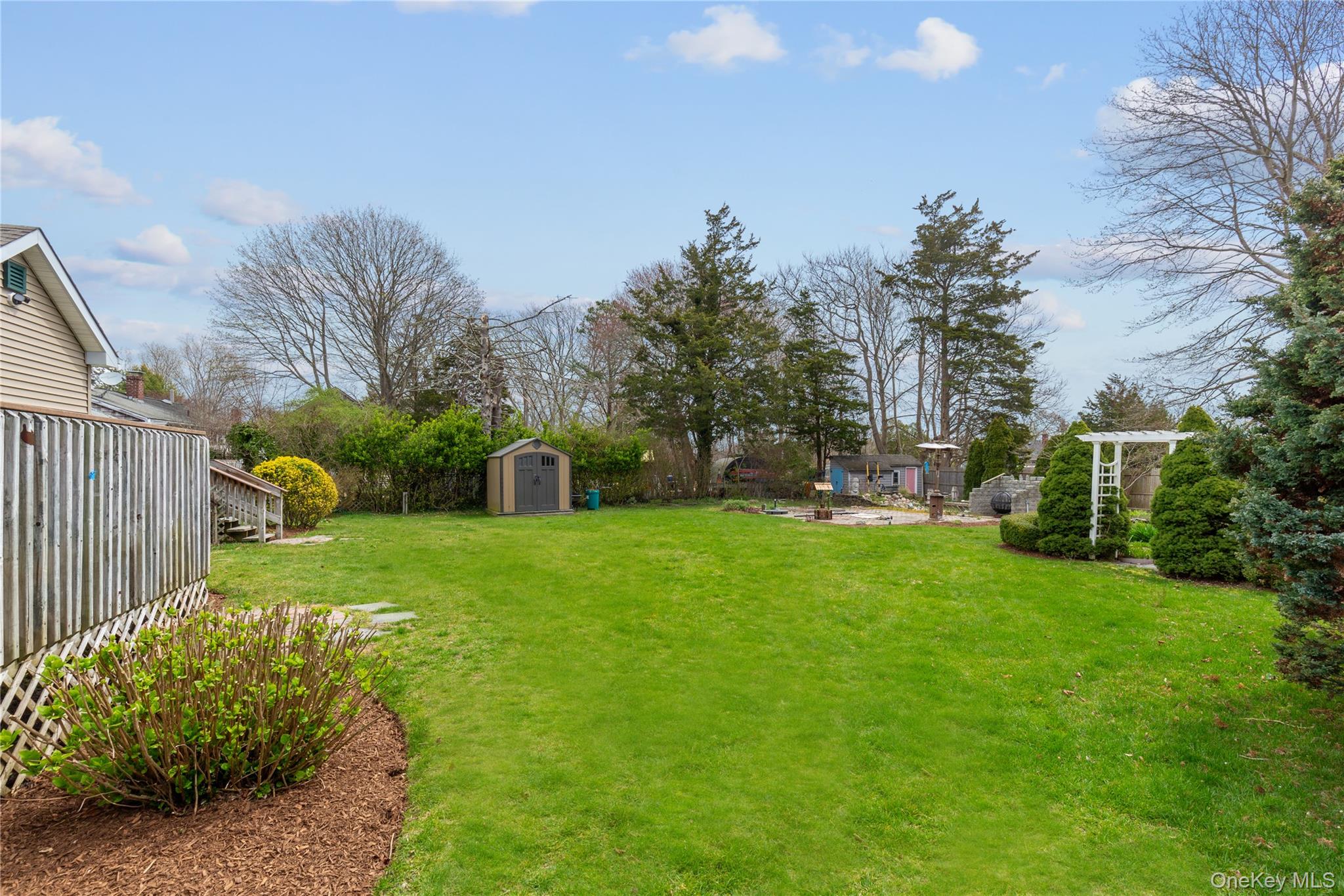 7 Suffolk Road Hampton Bays, NY 11946 - Photo 14 of 23 a view of a backyard with garden