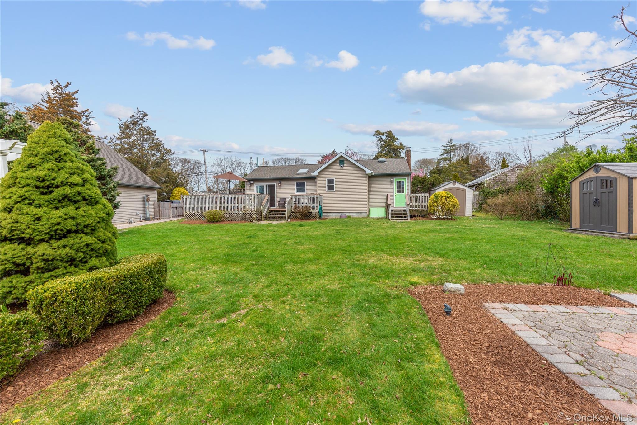 7 Suffolk Road Hampton Bays, NY 11946 - Photo 15 of 23 a view of a house with a big yard and large trees
