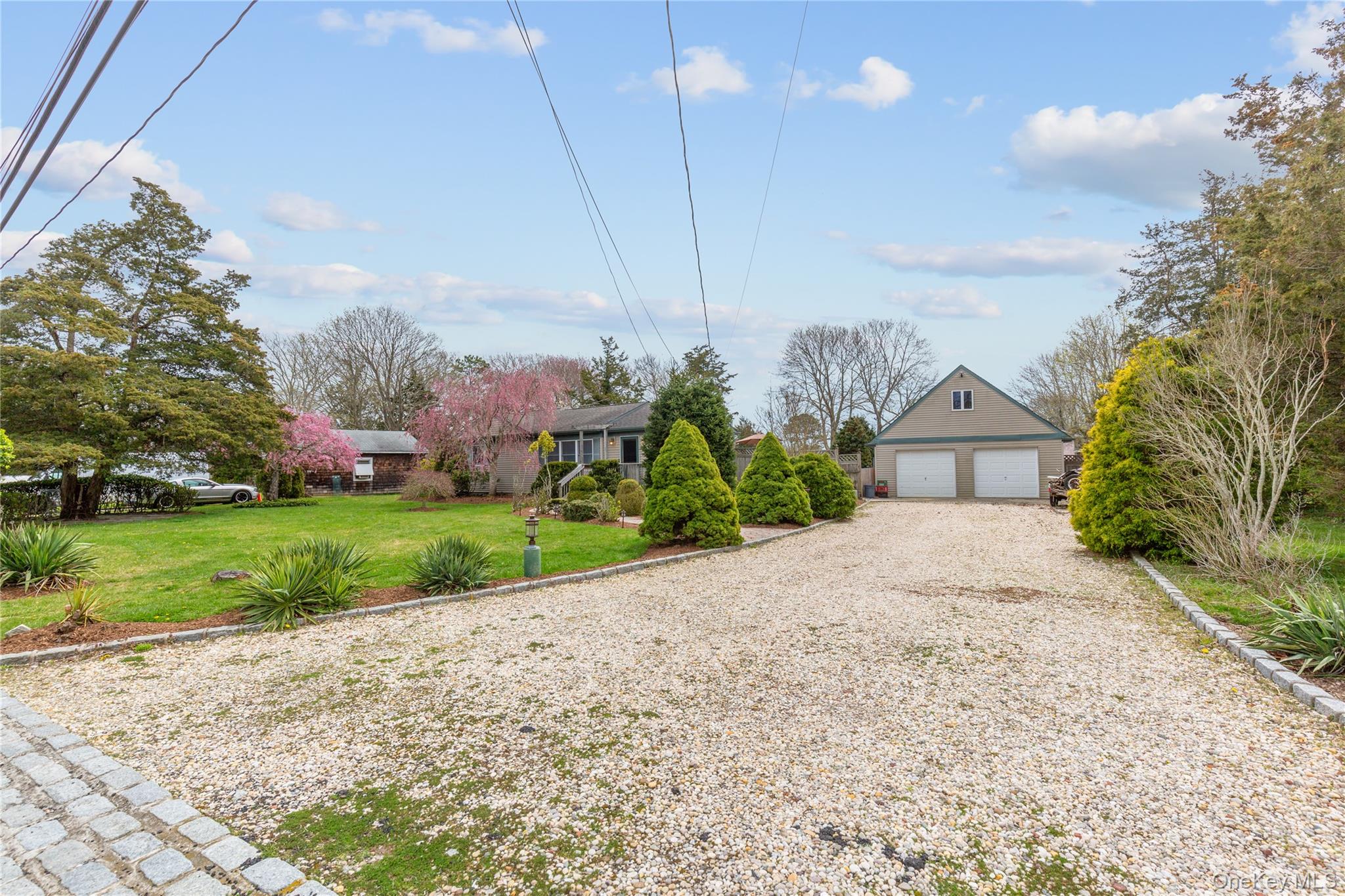 7 Suffolk Road Hampton Bays, NY 11946 - Photo 17 of 23 a front view of a house with garden