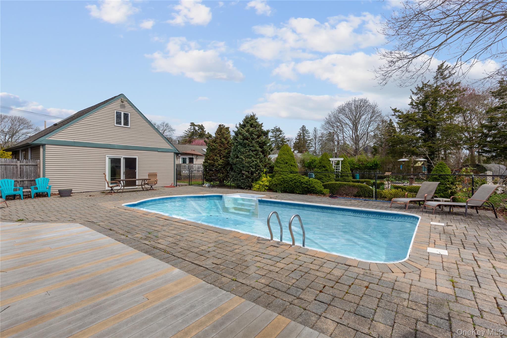 7 Suffolk Road Hampton Bays, NY 11946 - Photo 19 of 23 a front view of a house with swimming pool and sitting area