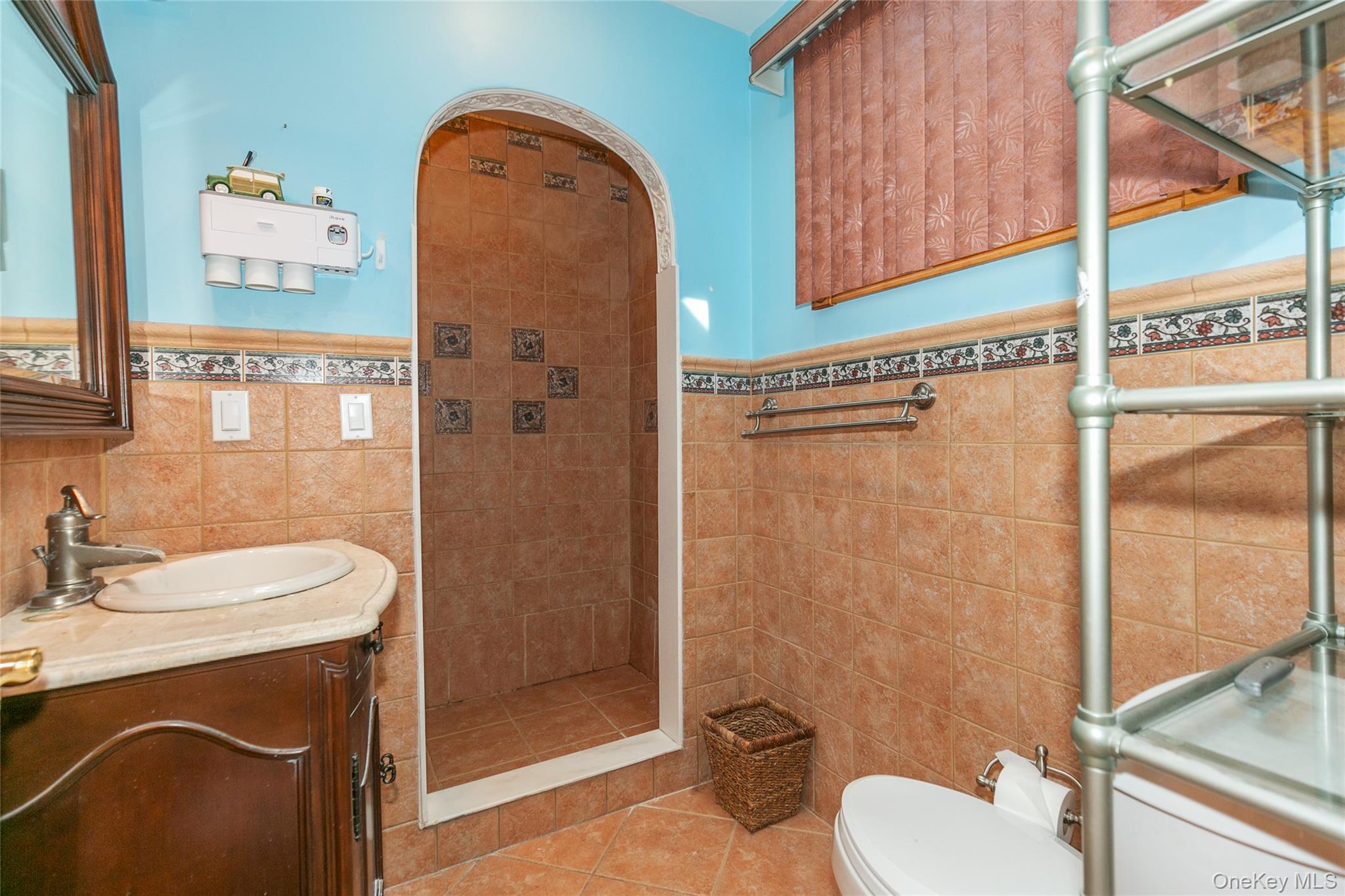 7 Suffolk Road Hampton Bays, NY 11946 - Photo 20 of 23 a bathroom with a sink a toilet and shower