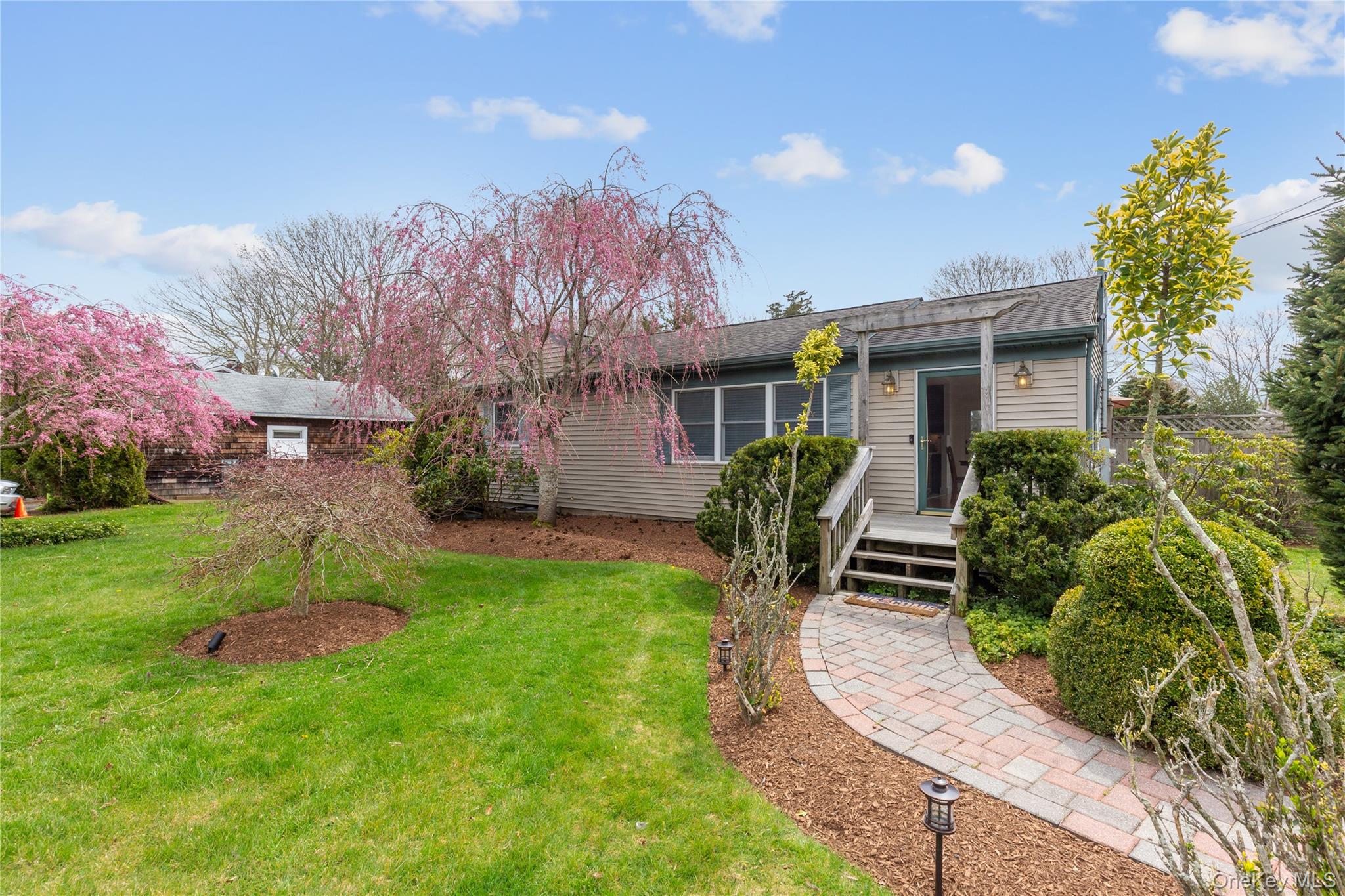 7 Suffolk Road Hampton Bays, NY 11946 - Photo 2 of 23 a front view of house with yard and green space