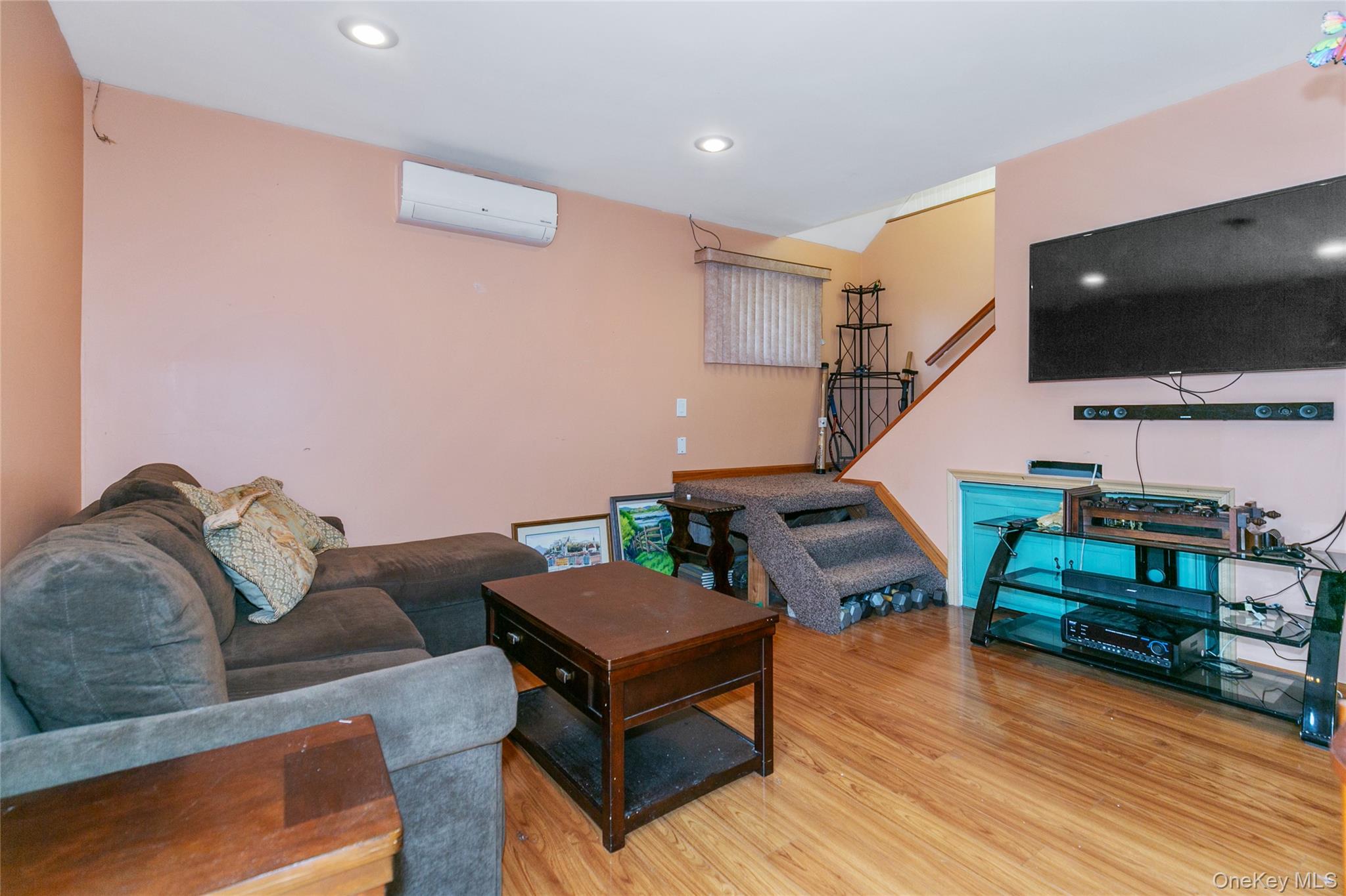 7 Suffolk Road Hampton Bays, NY 11946 - Photo 22 of 23 a living room with furniture and a flat screen tv
