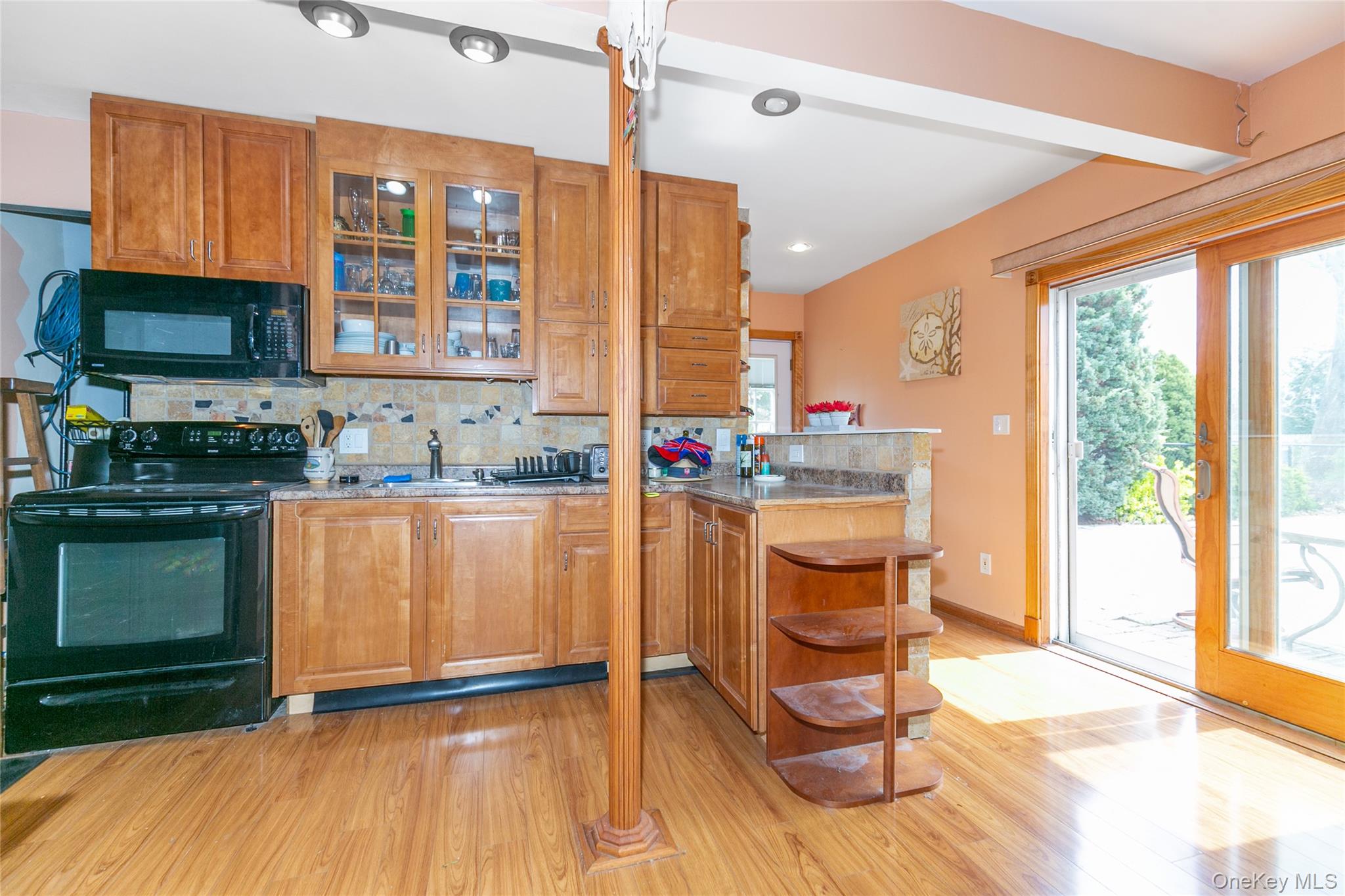 7 Suffolk Road Hampton Bays, NY 11946 - Photo 23 of 23 a kitchen with granite countertop a stove a sink and a wooden floors