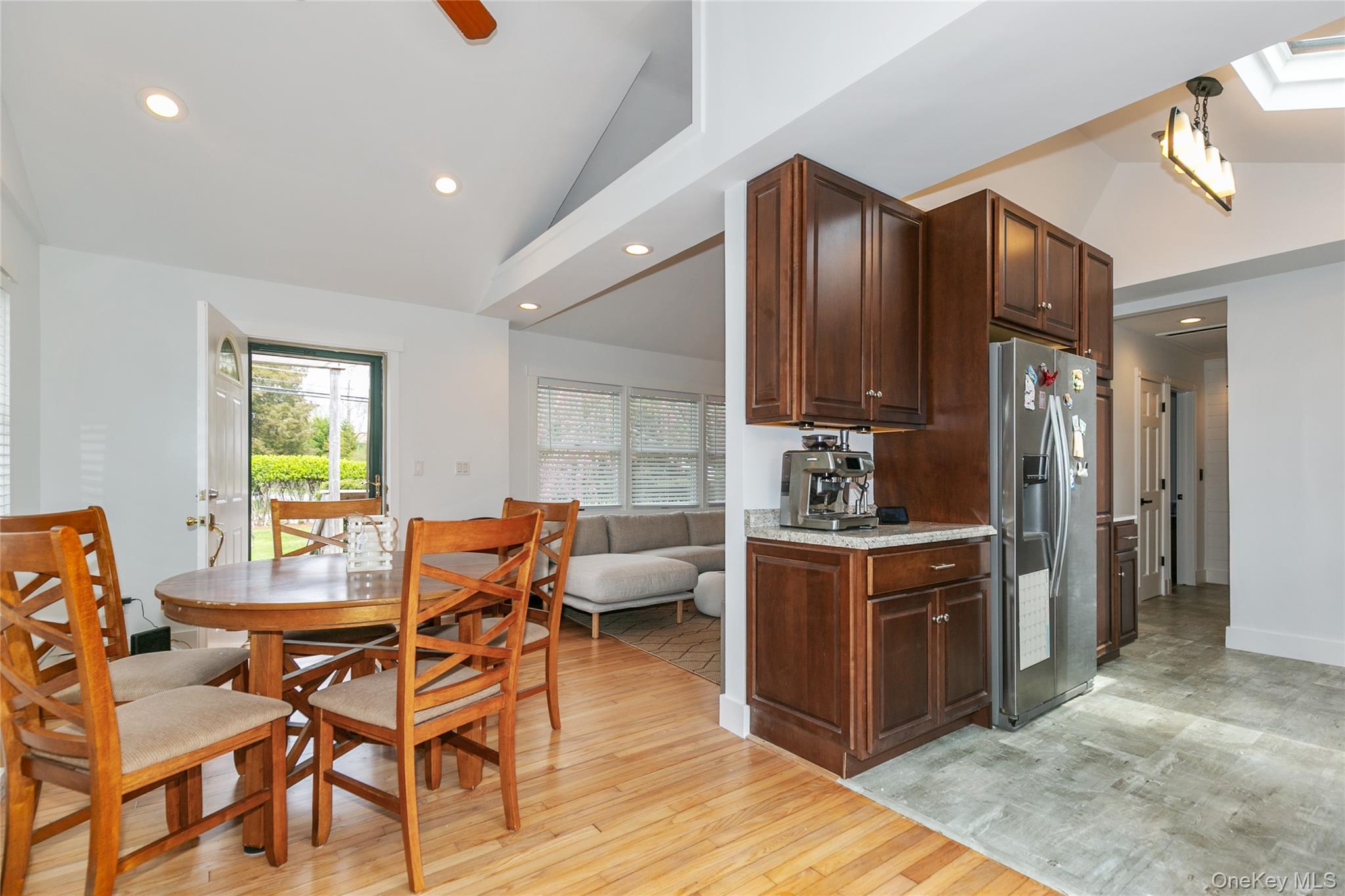7 Suffolk Road Hampton Bays, NY 11946 - Photo 6 of 23 a kitchen with stainless steel appliances wooden cabinets dining table and chairs