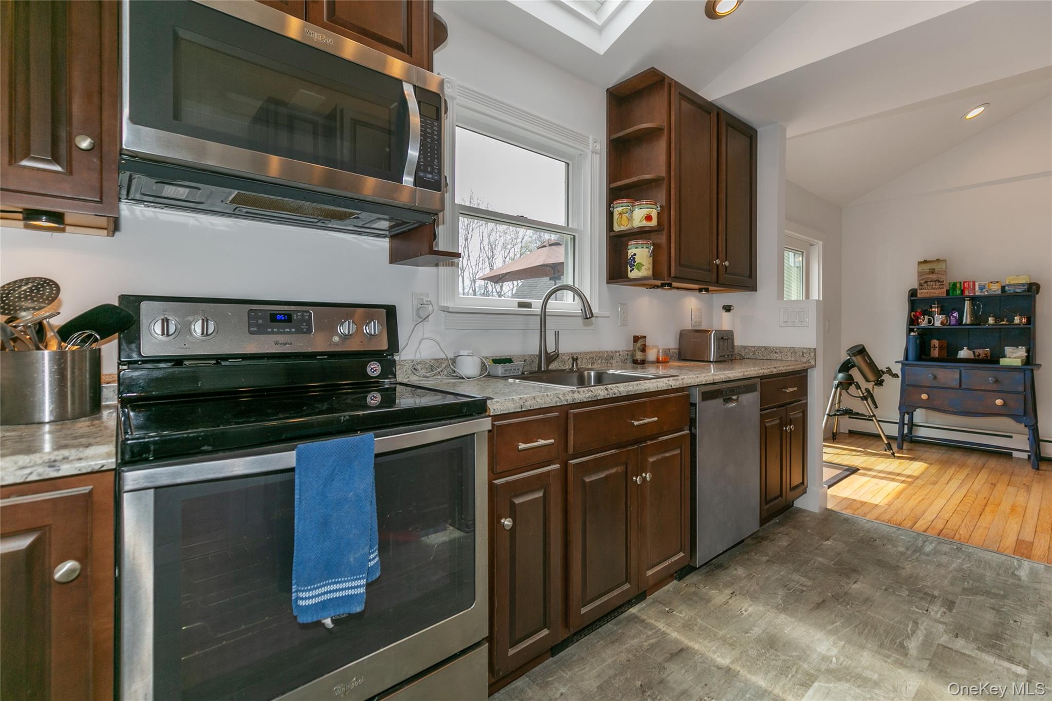 7 Suffolk Road Hampton Bays, NY 11946 - Photo 9 of 23 a kitchen with stainless steel appliances granite countertop a stove microwave and sink