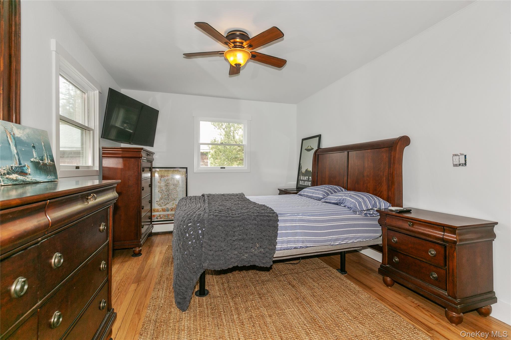 7 Suffolk Road Hampton Bays, NY 11946 - Photo 10 of 23 a bedroom with a bed and wooden floor