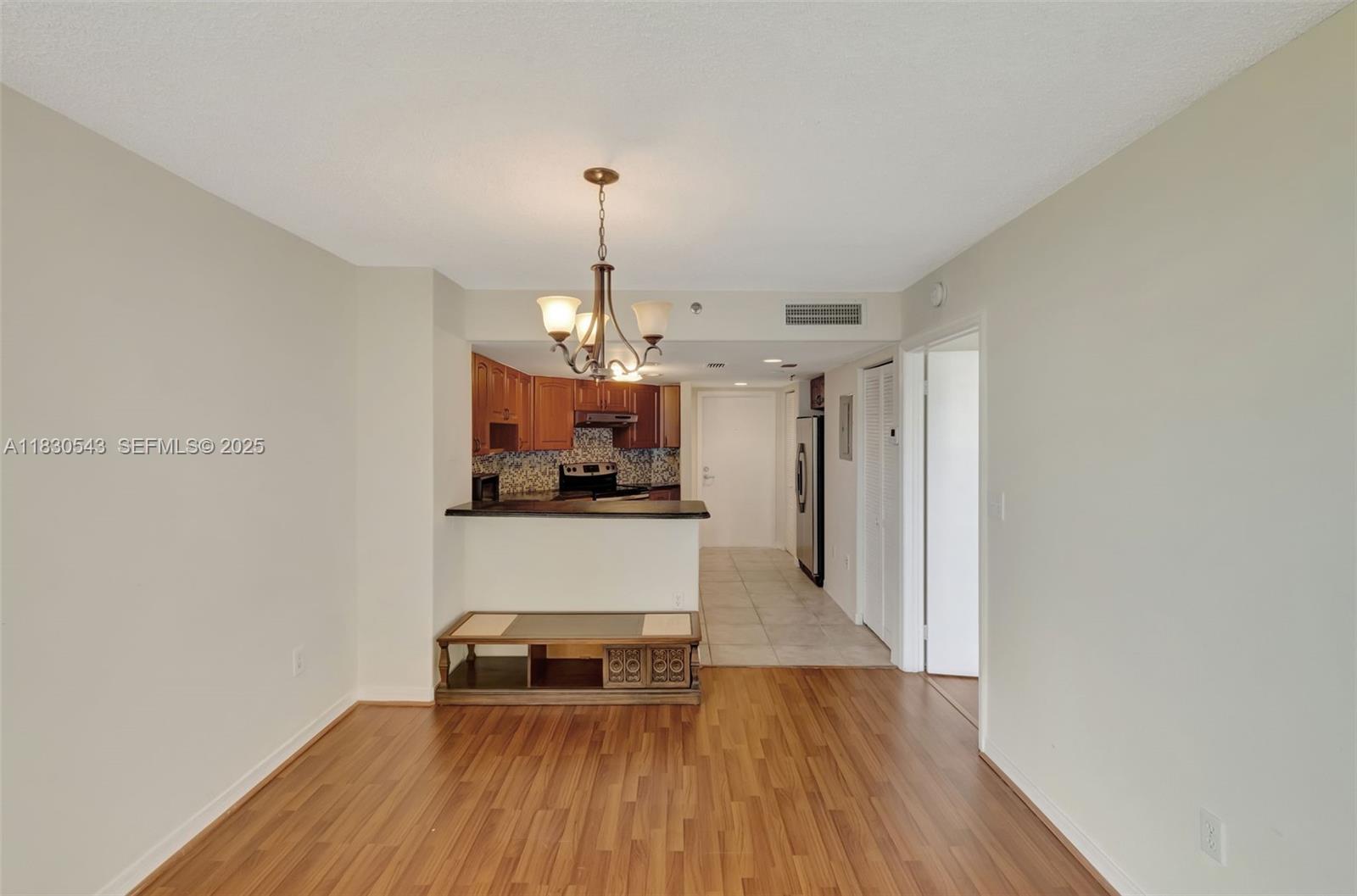 2400 Southwest 3rd Avenue, Unit 506 Miami, FL 33129 - Photo 11 of 28 a view of a kitchen with a sink wooden cabinets and a wooden floor