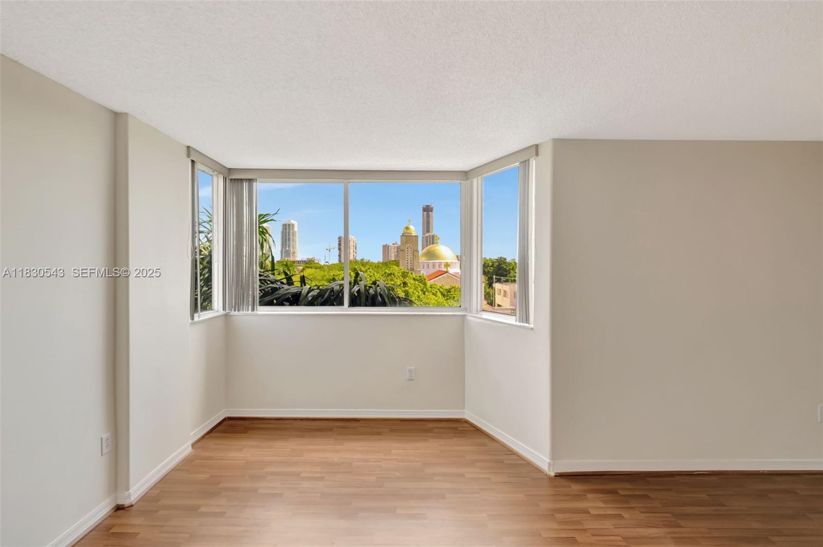 2400 Southwest 3rd Avenue, Unit 506 Miami, FL 33129 - Photo 14 of 28 a view of an empty room with wooden floor and a window