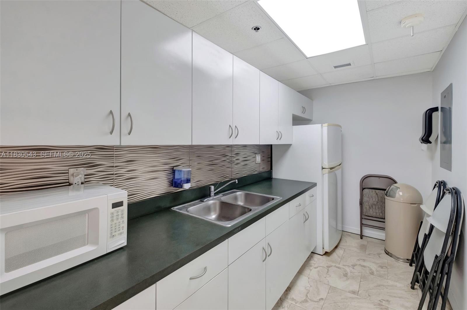 2400 Southwest 3rd Avenue, Unit 506 Miami, FL 33129 - Photo 26 of 28 a kitchen with stainless steel appliances granite countertop a sink stove and refrigerator