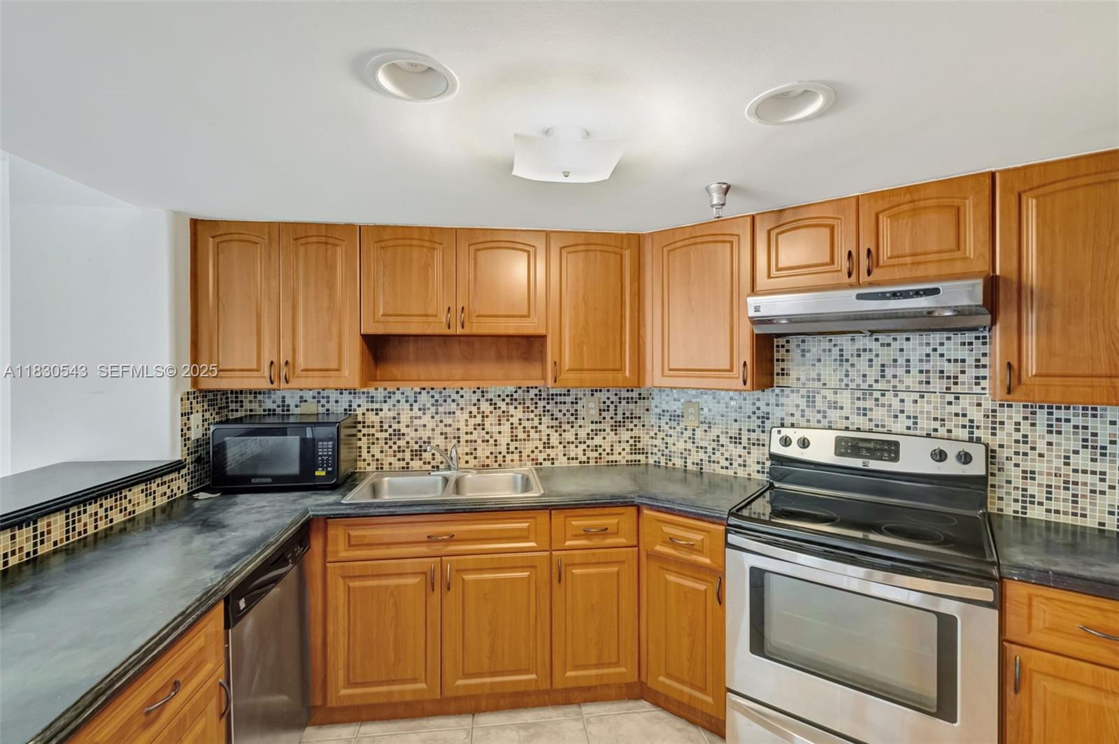 2400 Southwest 3rd Avenue, Unit 506 Miami, FL 33129 - Photo 10 of 28 a kitchen with granite countertop a sink stove and cabinets