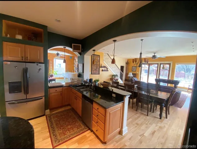 a kitchen with stainless steel appliances granite countertop a stove and a refrigerator