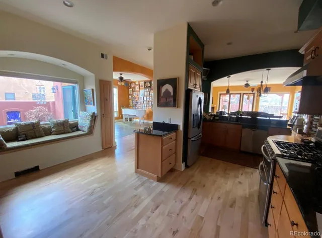 a kitchen with stainless steel appliances granite countertop wooden floors and sink