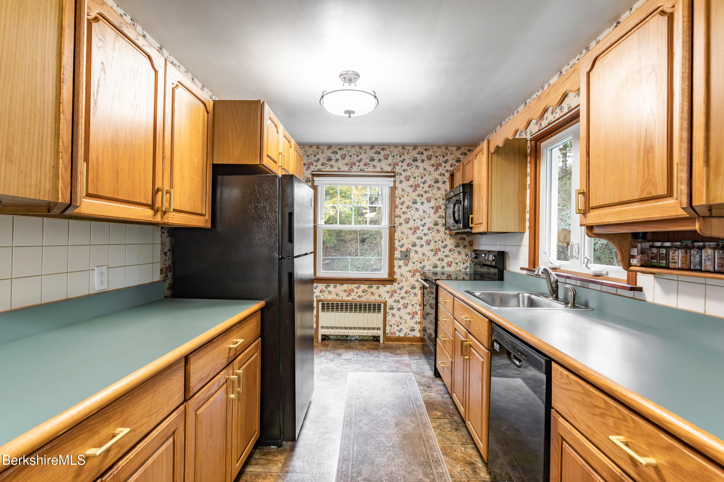 139 Gamwell Avenue Pittsfield, MA 01201 - Photo 8 of 33 a kitchen with stainless steel appliances granite countertop a sink a stove and a refrigerator