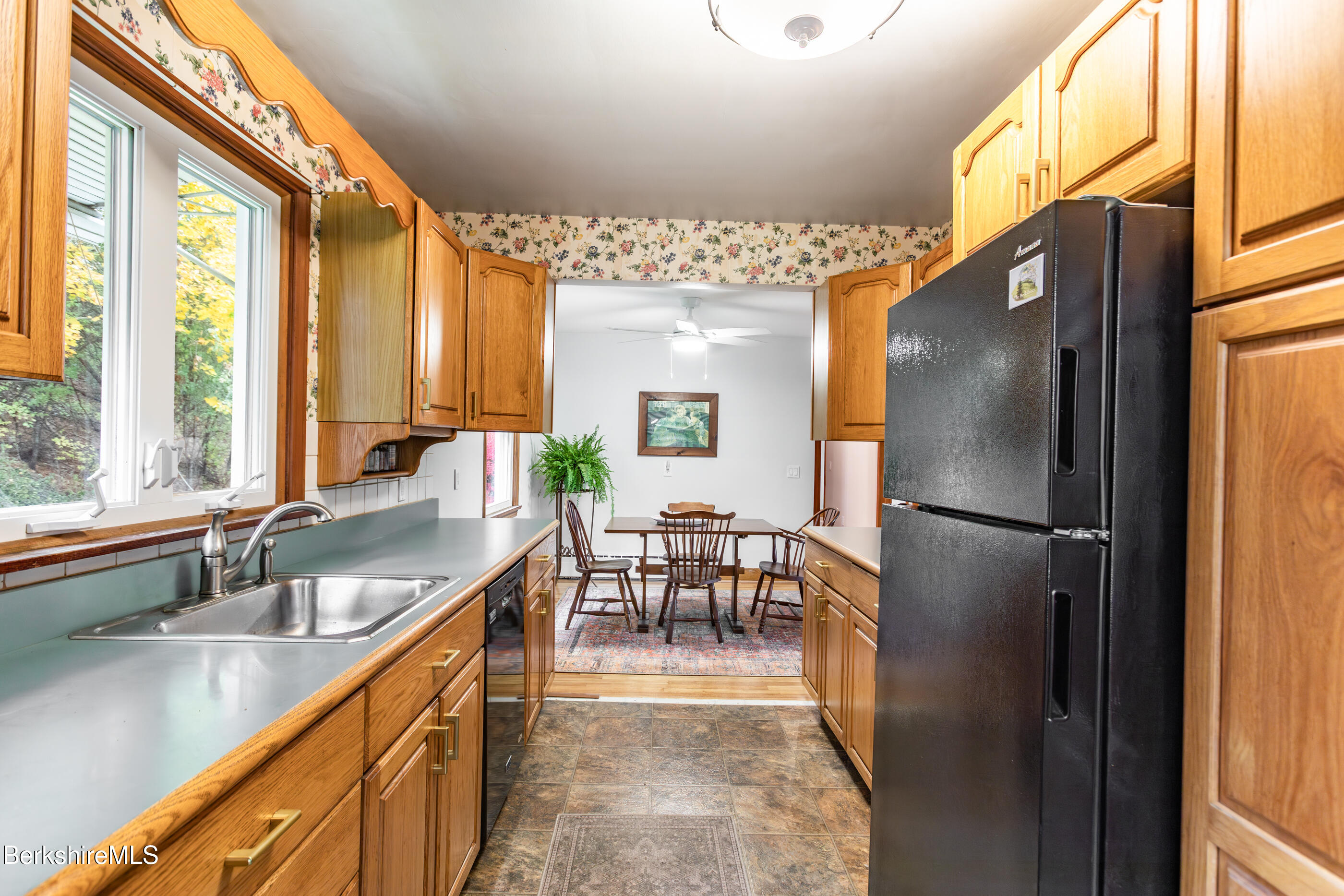 139 Gamwell Avenue Pittsfield, MA 01201 - Photo 9 of 33 a kitchen with stainless steel appliances granite countertop a refrigerator a sink a stove and a dining table with wooden floor