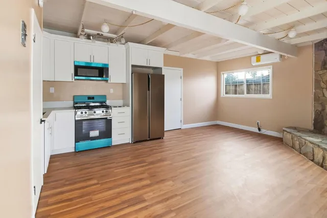 a kitchen with stainless steel appliances a refrigerator and a stove top oven
