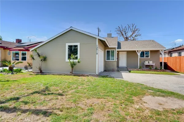 a view of a house with backyard and sitting area