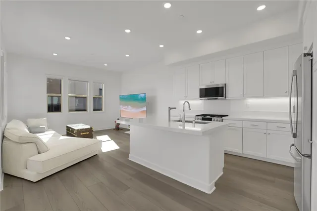 a view of kitchen with stainless steel appliances a refrigerator and a stove top oven