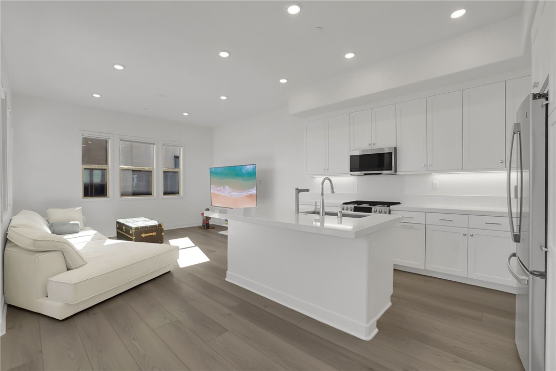 1958 Hollyleaf Terrace Montebello, CA 90640 - Photo 12 of 58 a living room with stainless steel appliances kitchen island furniture and a wooden floor